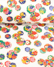 Japanese chiyogami paper featuring yukiwa (snowflake) with various floral and geometric designs on a pearlescent white background with metallic gold accents.