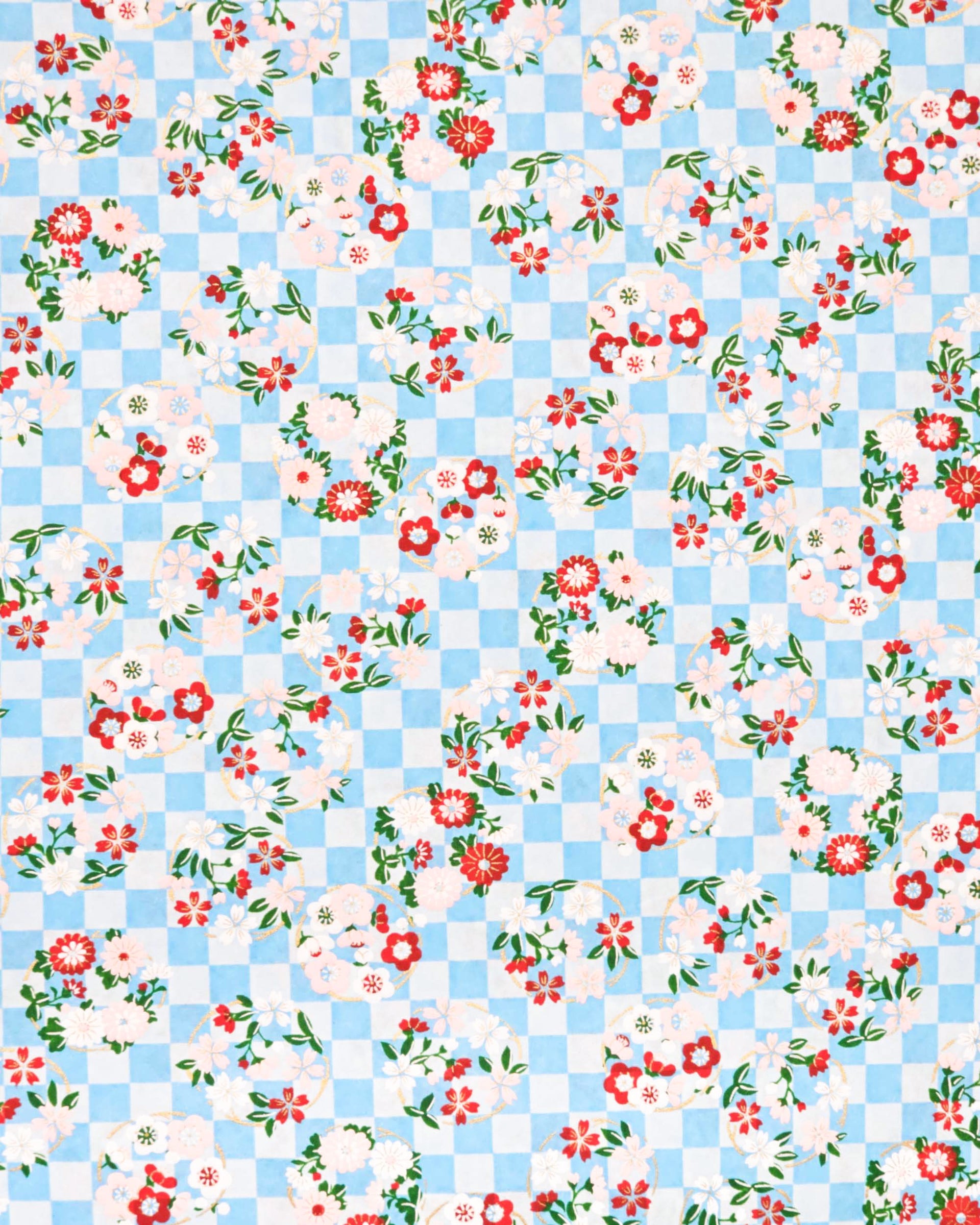 Japanese chiyogami paper featuring light pink, red, and white flowers with green leaves on a light blue ichimatsu (checkered) background with metallic gold accents.
