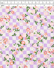 Japanese chiyogami paper featuring light pink, red, and white flowers with green leaves on a light purple ichimatsu (checkered) background with metallic gold accents.