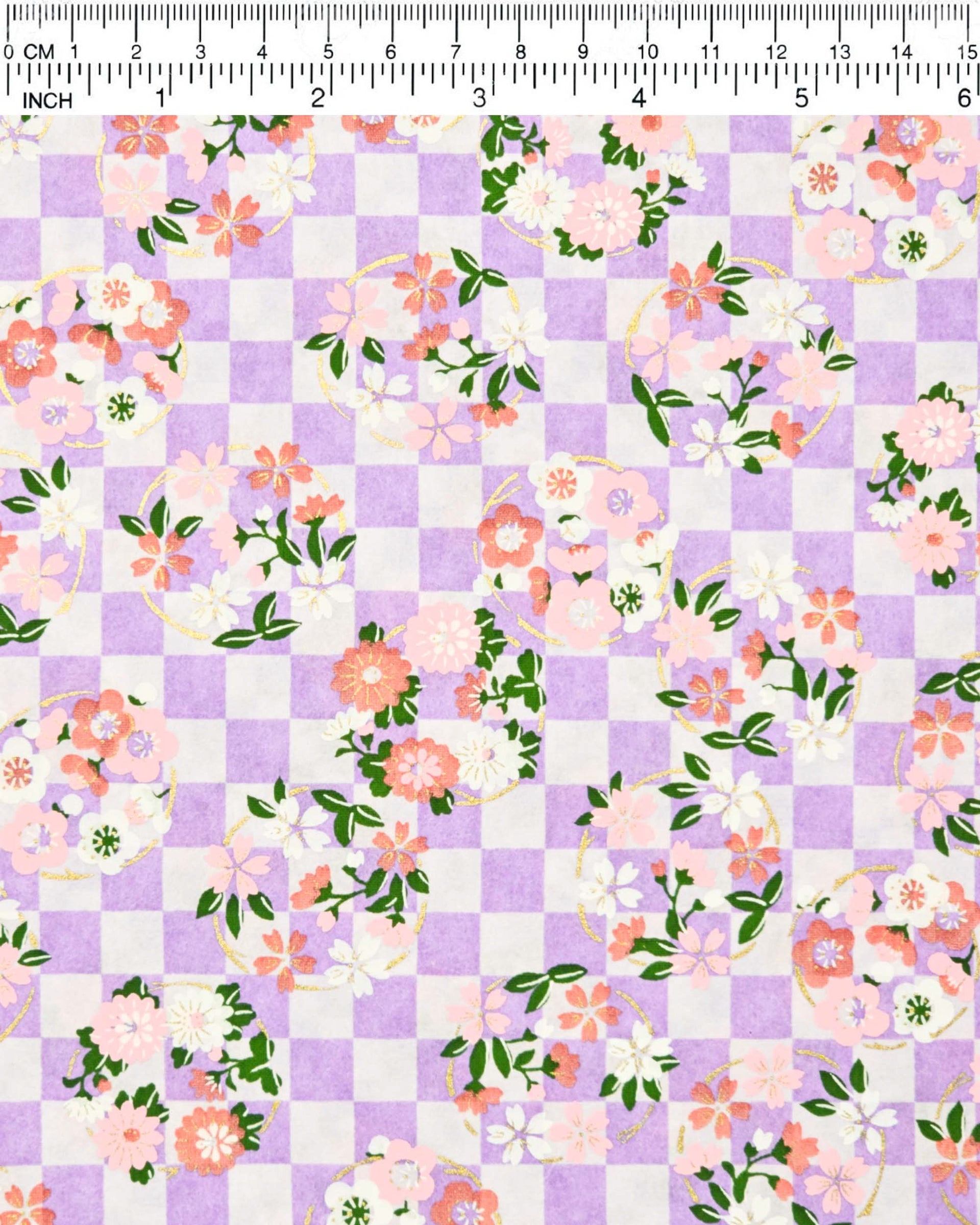 Japanese chiyogami paper featuring light pink, red, and white flowers with green leaves on a light purple ichimatsu (checkered) background with metallic gold accents.