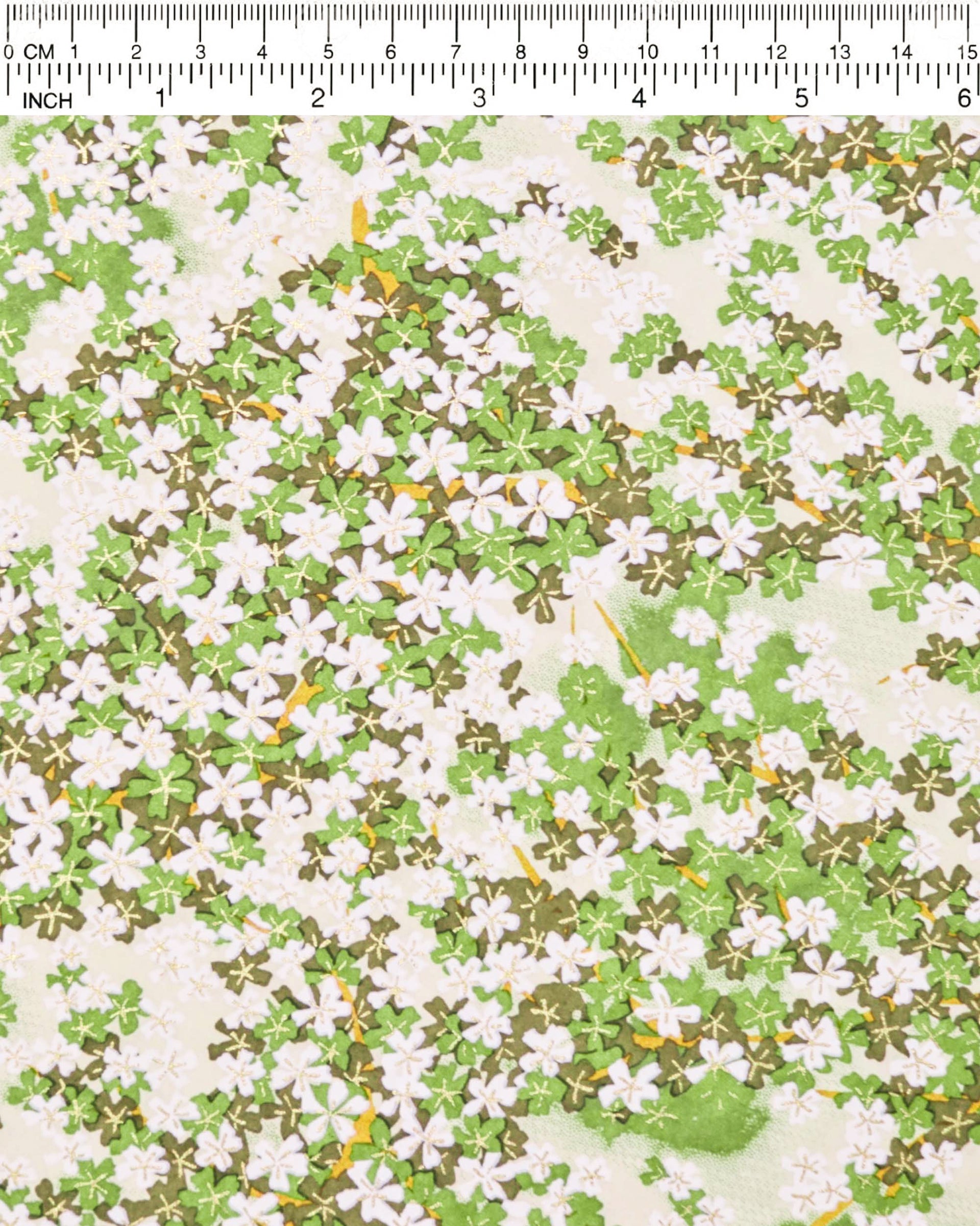 Japanese chiyogami paper featuring green and white cherry blossoms with light green branches on a green background with metallic gold accents.