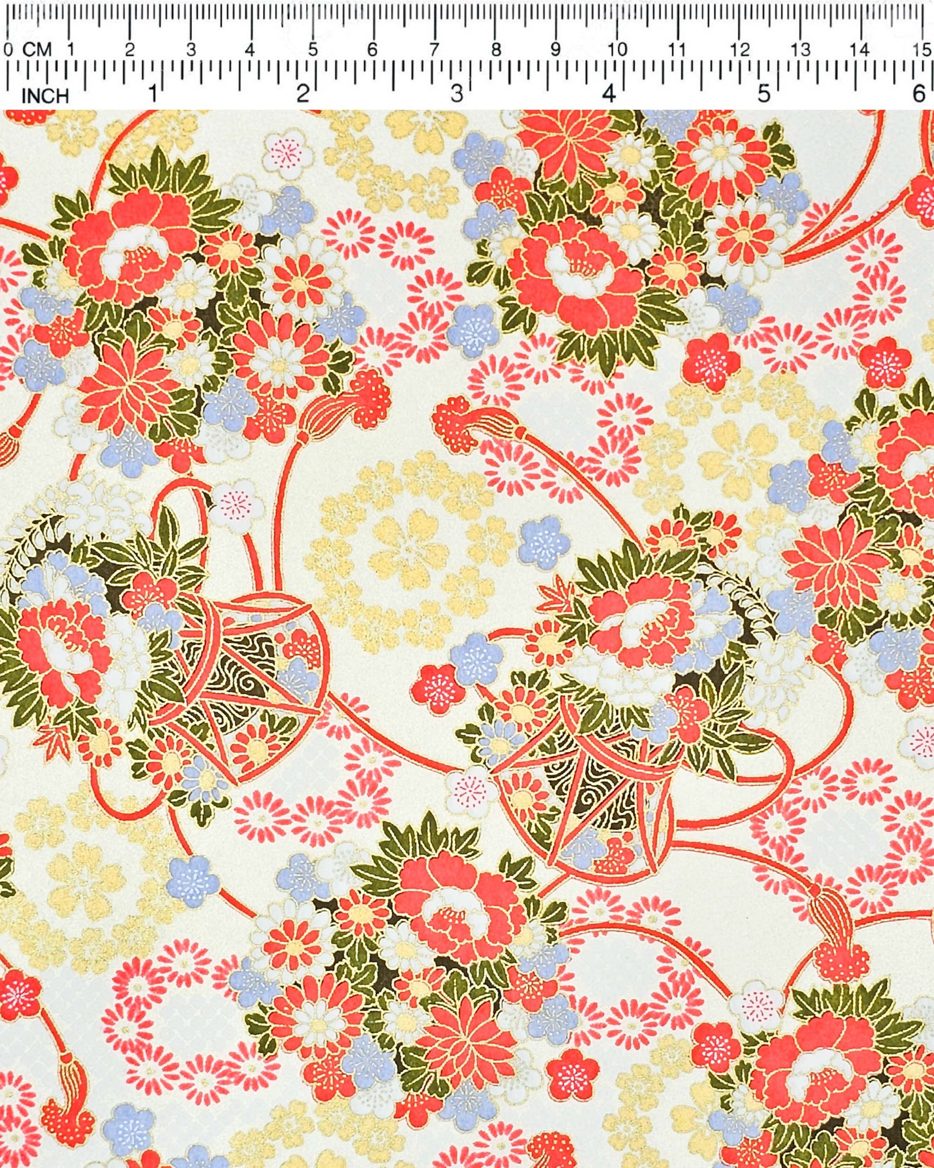 Japanese chiyogami paper featuring assorted red, light blue, and white flowers with green leaves inside red drums on a pearlescent white background with metallic gold accents. 