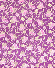 Japanese chiyogami paper featuring pink cherry blossoms alongside gold cherry blossoms and leaves decorated with a traditional kanoko (fawn) pattern on a purple background with metallic gold details.