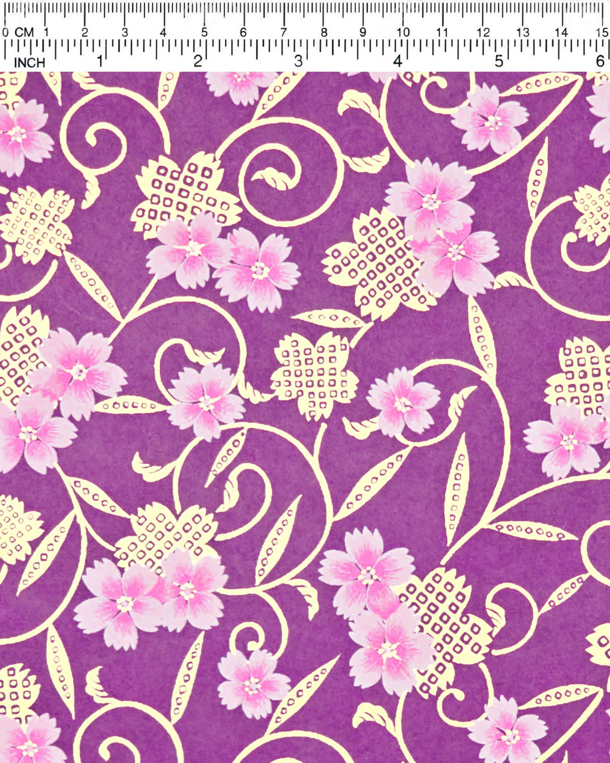 Japanese chiyogami paper featuring pink cherry blossoms alongside gold cherry blossoms and leaves decorated with a traditional kanoko (fawn) pattern on a purple background with metallic gold details, shown next to a ruler for size reference.