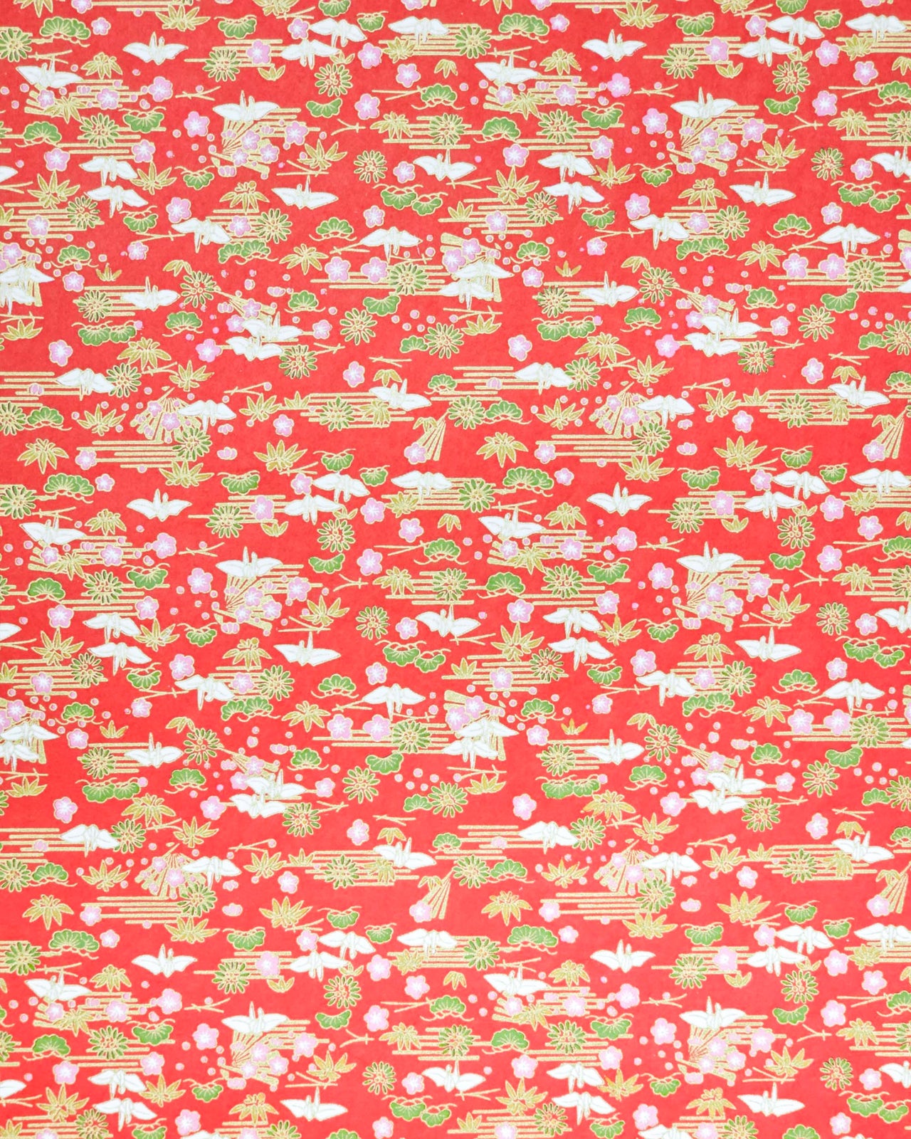 Japanese chiyogami paper featuring small white folded origami cranes with green pine and pink plum blossoms on a red background with metallic gold accents.
