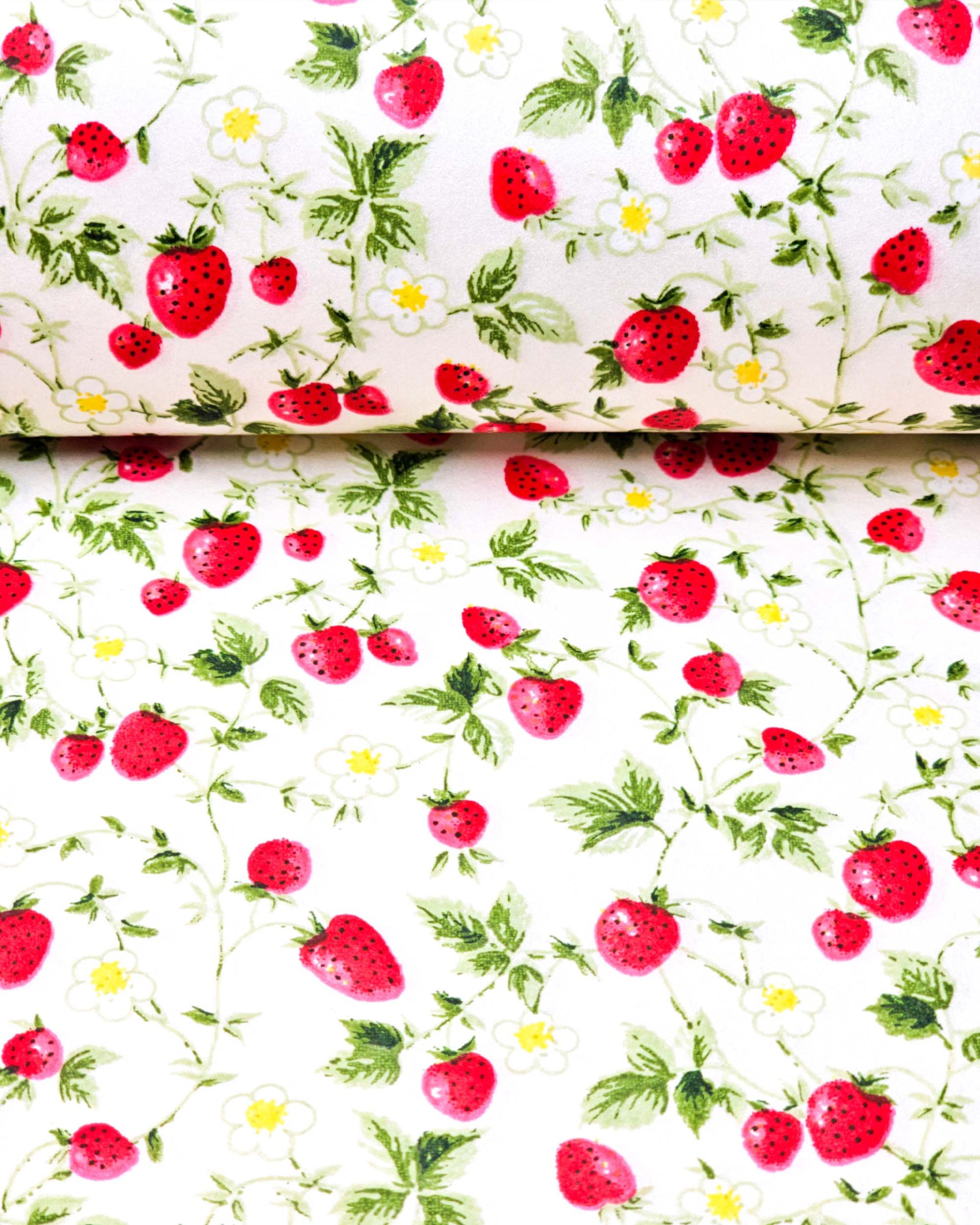 Japanese chiyogami paper featuring red strawberries with green leaves and white flowers with yellow centers on a pearlescent white background, shown rolled to highlight the design.
