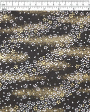 Japanese chiyogami paper featuring small white and gold cherry blossoms on a black background with metallic gold details, shown next to a ruler for size reference.