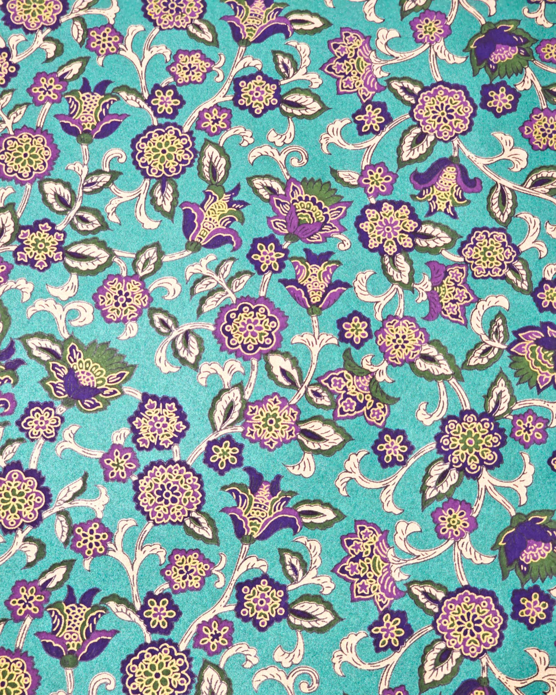 Japanese chiyogami paper featuring purple and green sarasa flowers on a pearlescent green background with metallic gold accents.