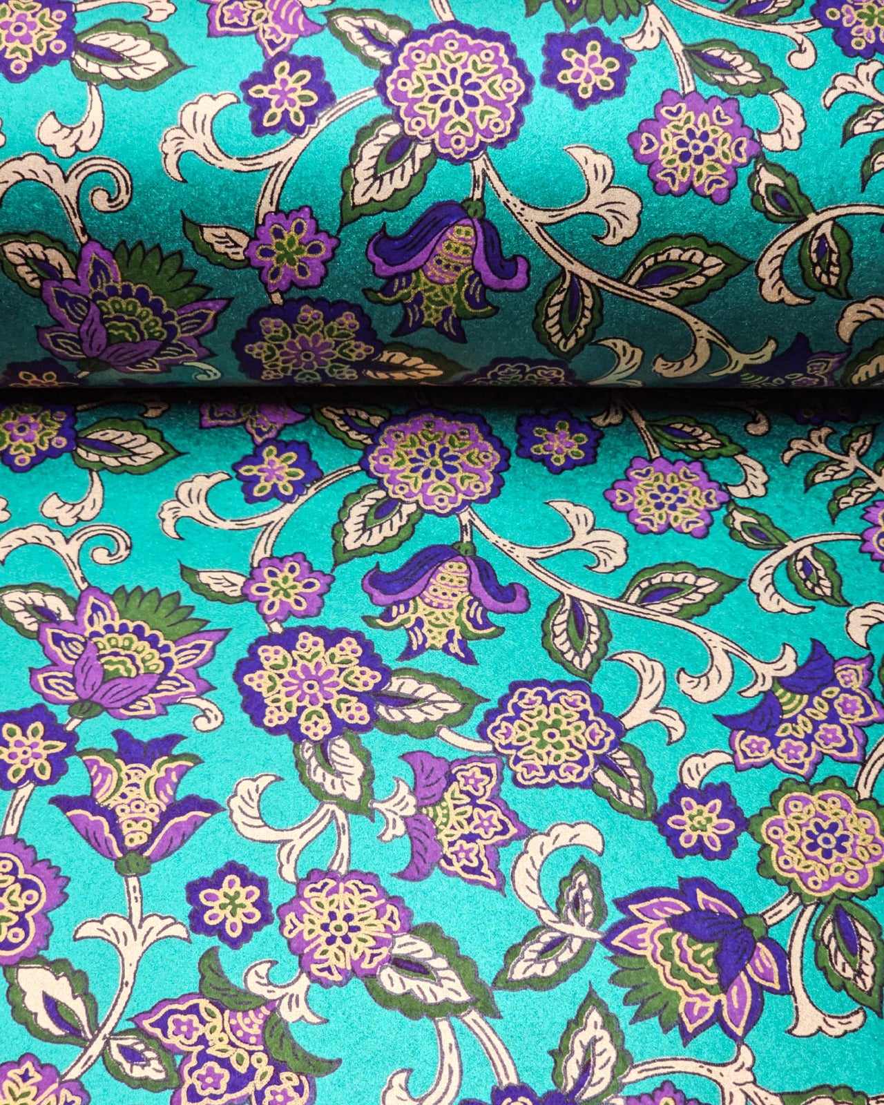 Japanese chiyogami paper featuring purple and green sarasa flowers on a pearlescent green background with metallic gold accents.