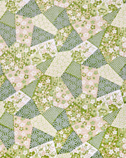 Japanese chiyogami paper featuring green, beige, and white floral patches embedded with assorted geometric and floral designs with metallic gold details.