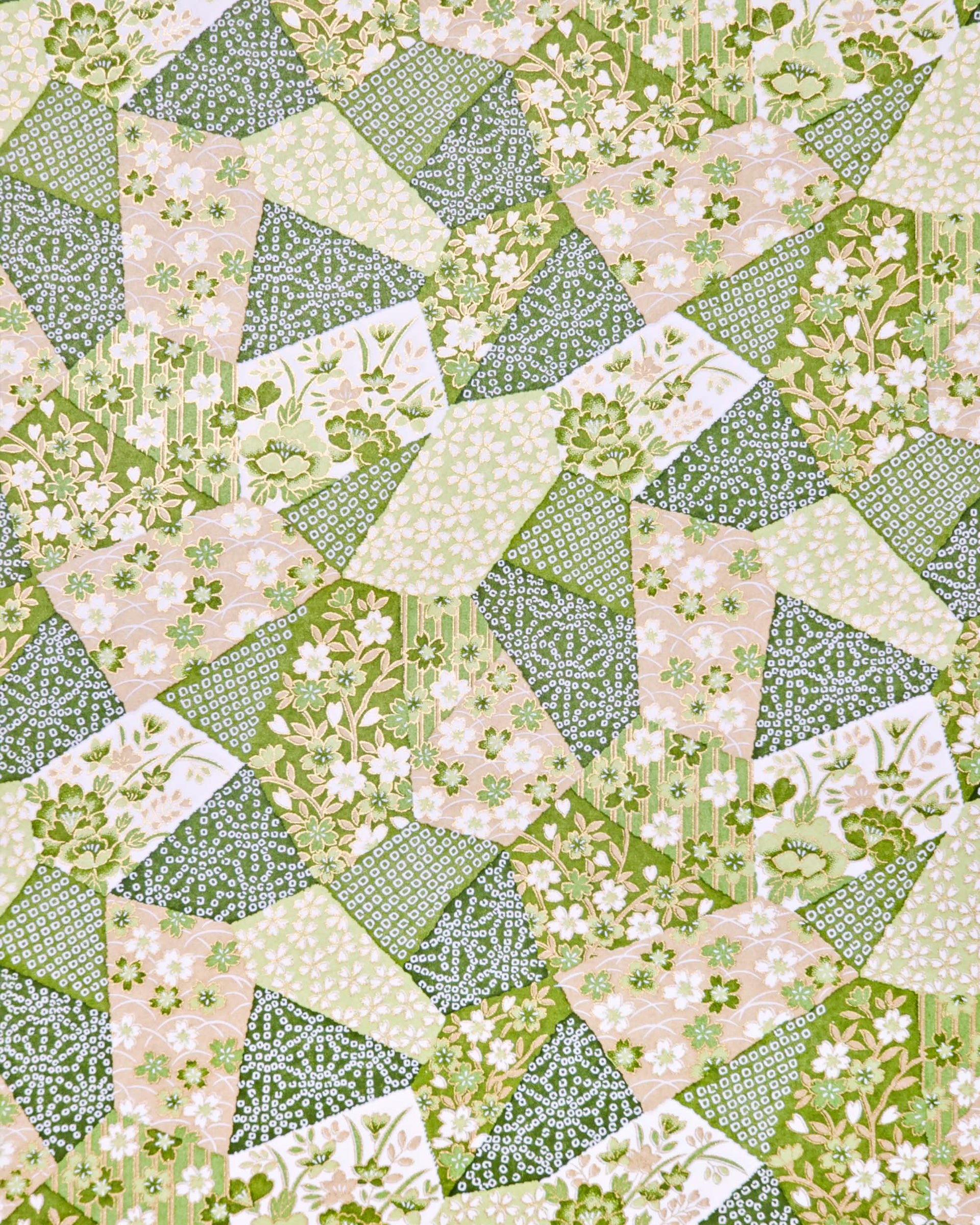 Japanese chiyogami paper featuring green, beige, and white floral patches embedded with assorted geometric and floral designs with metallic gold details.