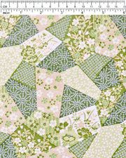 Japanese chiyogami paper featuring green, beige, and white floral patches embedded with assorted geometric and floral designs with metallic gold details, shown next to a ruler for size reference.