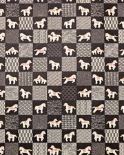 Japanese chiyogami paper featuring white horses with red and green accents and beige assorted traditional Japanese designs in an ichimatsu (checker) design on a black background with metallic gold accents.