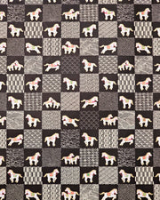 Japanese chiyogami paper featuring white horses with gold manes wearing red and green saddles and bridles, alternating with assorted off-white traditional Japanese patterns in an ichimatsu (checker) design on a black background.