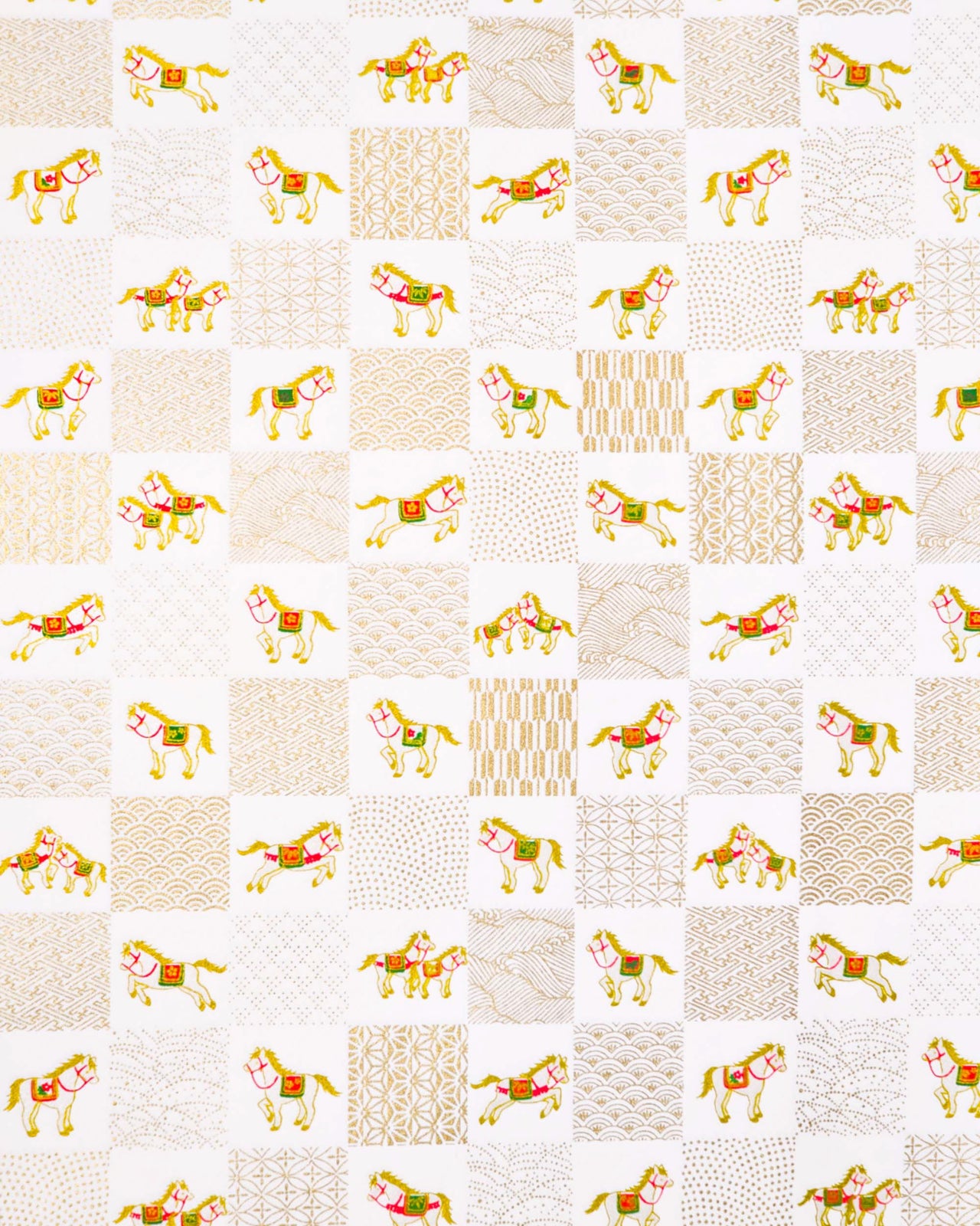 Japanese chiyogami paper featuring silver horses with red and green accents and gold assorted traditional Japanese designs in an ichimatsu (checker) design on a white background with metallic gold accents.