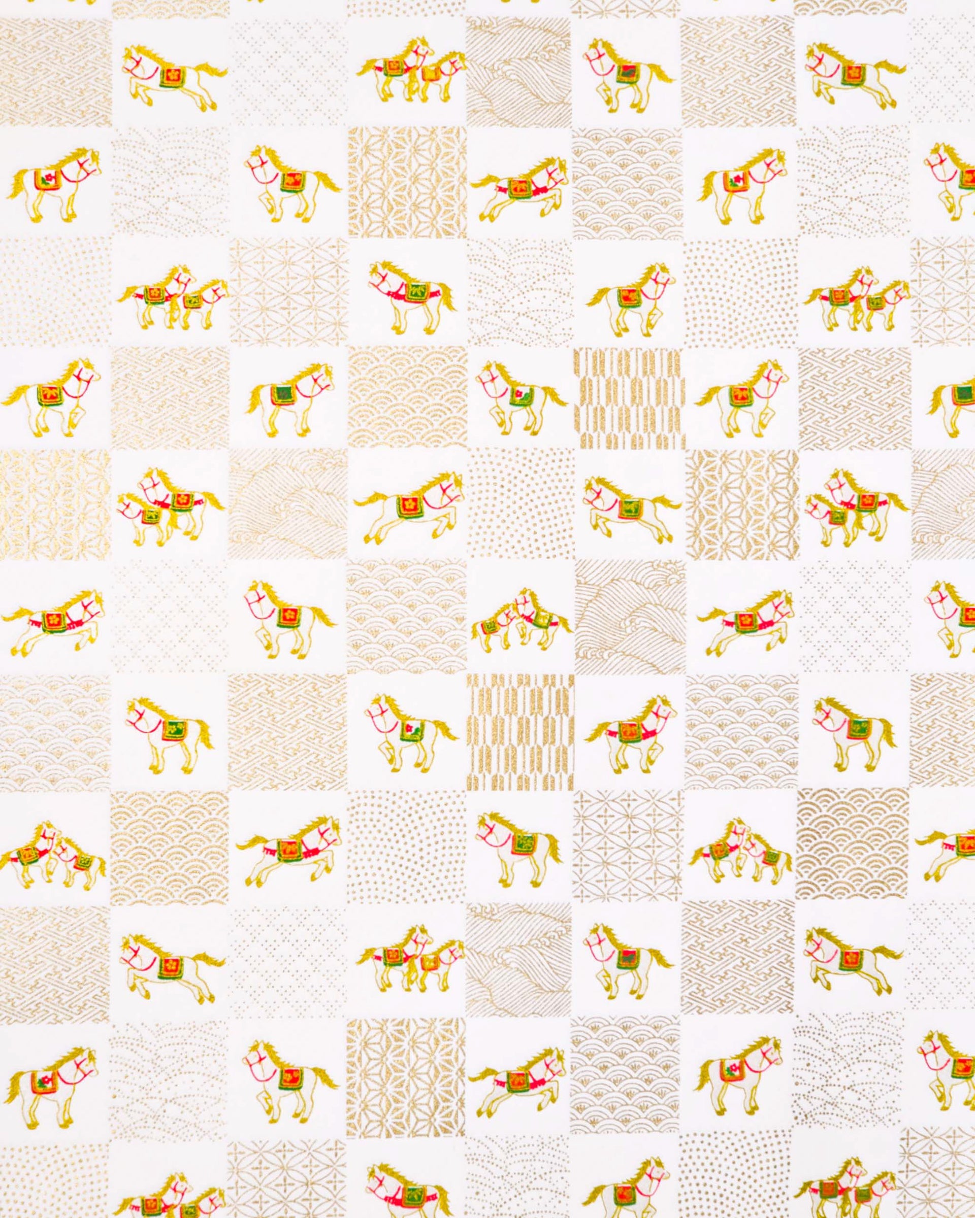 Japanese chiyogami paper featuring silver horses with red and green accents and gold assorted traditional Japanese designs in an ichimatsu (checker) design on a white background with metallic gold accents.