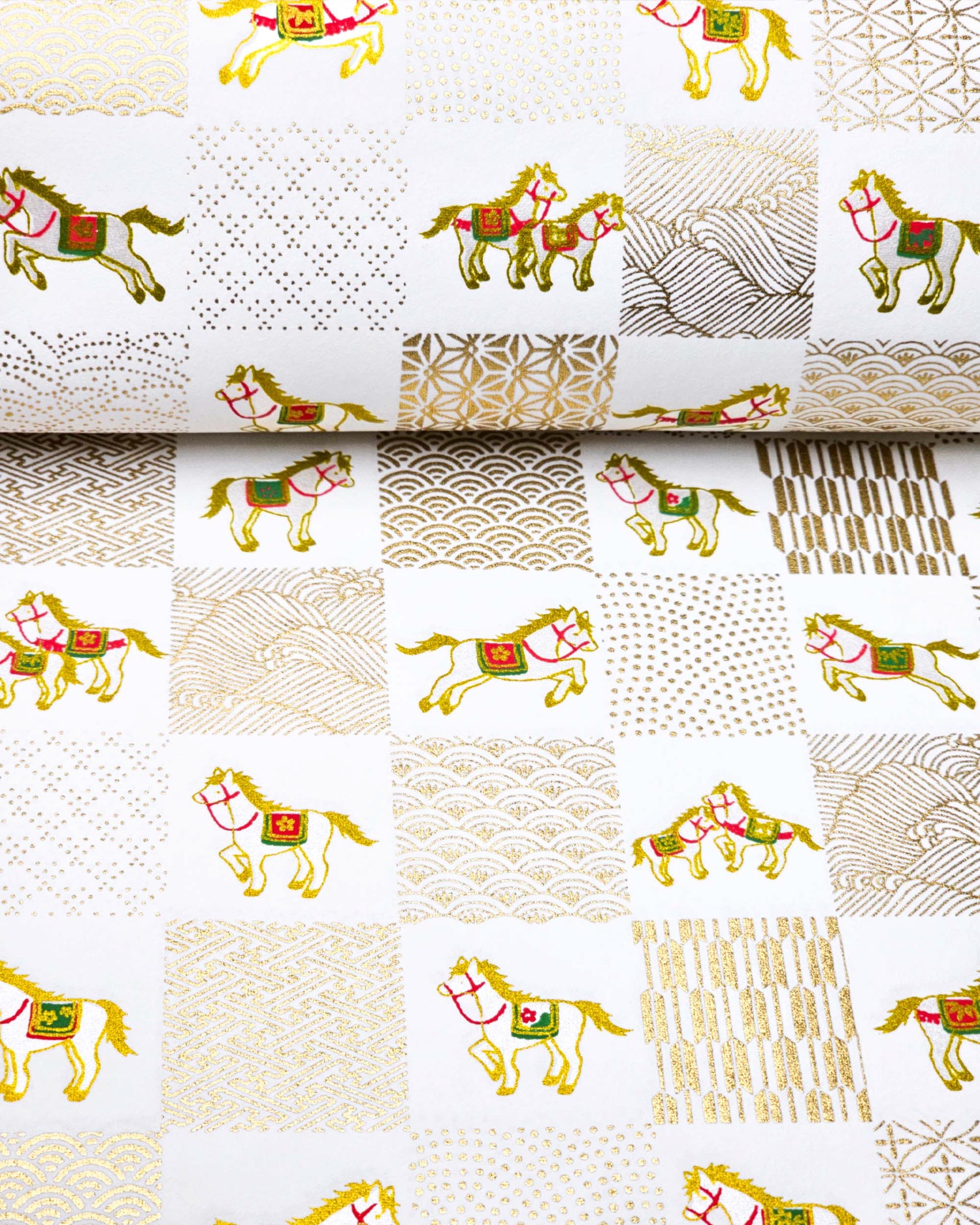 Japanese chiyogami paper featuring silver horses with red and green accents and gold assorted traditional Japanese designs in an ichimatsu (checker) design on a white background with metallic gold accents.