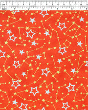 Japanese chiyogami paper featuring white assorted stars and smaller metallic gold stars and constellations on a red background, shown next to a ruler for size reference.