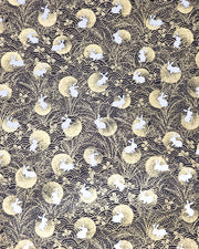Japanese chiyogami paper featuring white rabbits with gold moons on a black background with metallic gold accents.