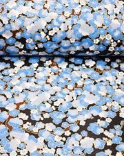 Japanese chiyogami paper featuring a blue plum blossom tree on a black background with metallic gold accents.