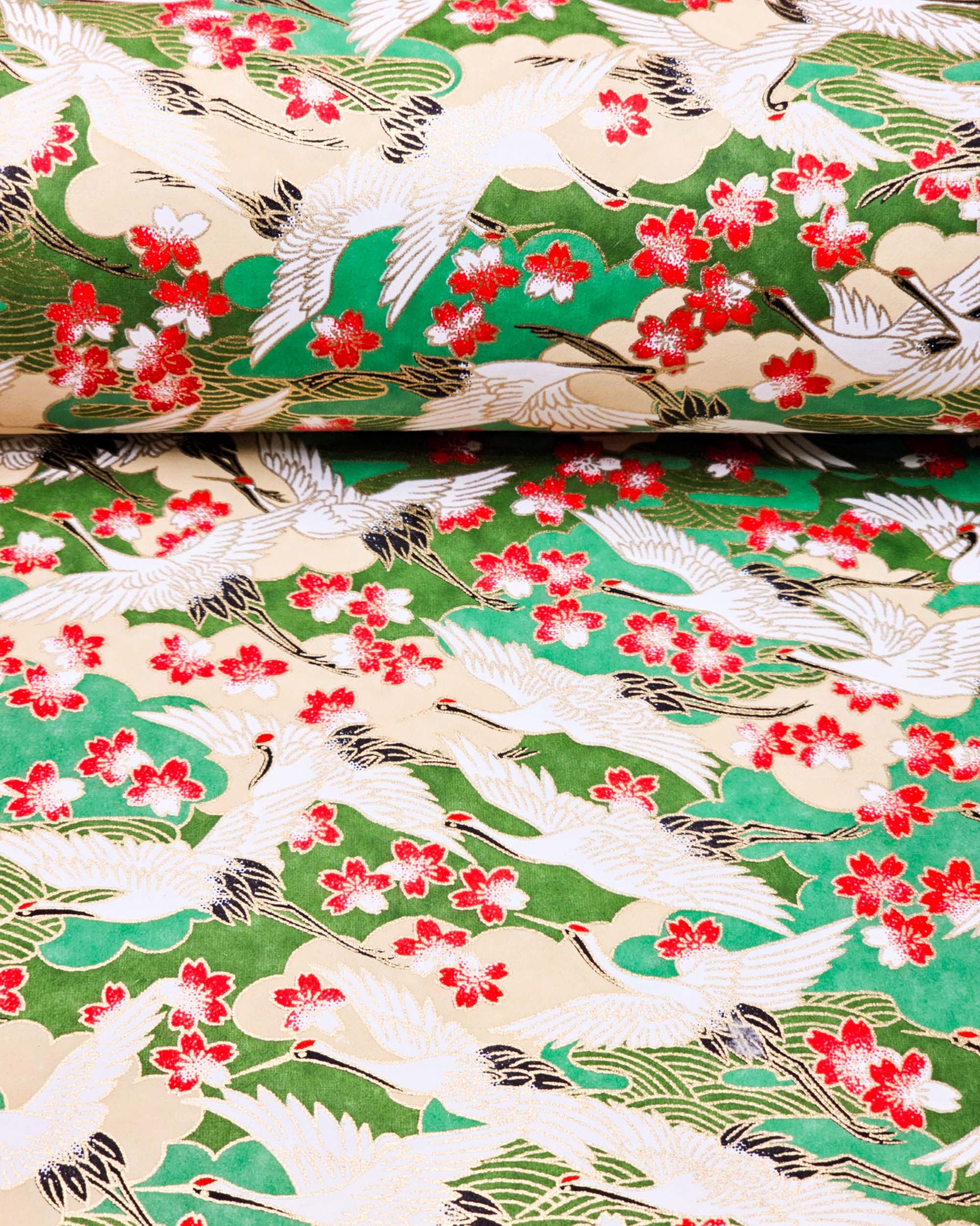 Japanese chiyogami paper featuring cranes and red cherry blossoms on a green and beige background with metallic gold accents.