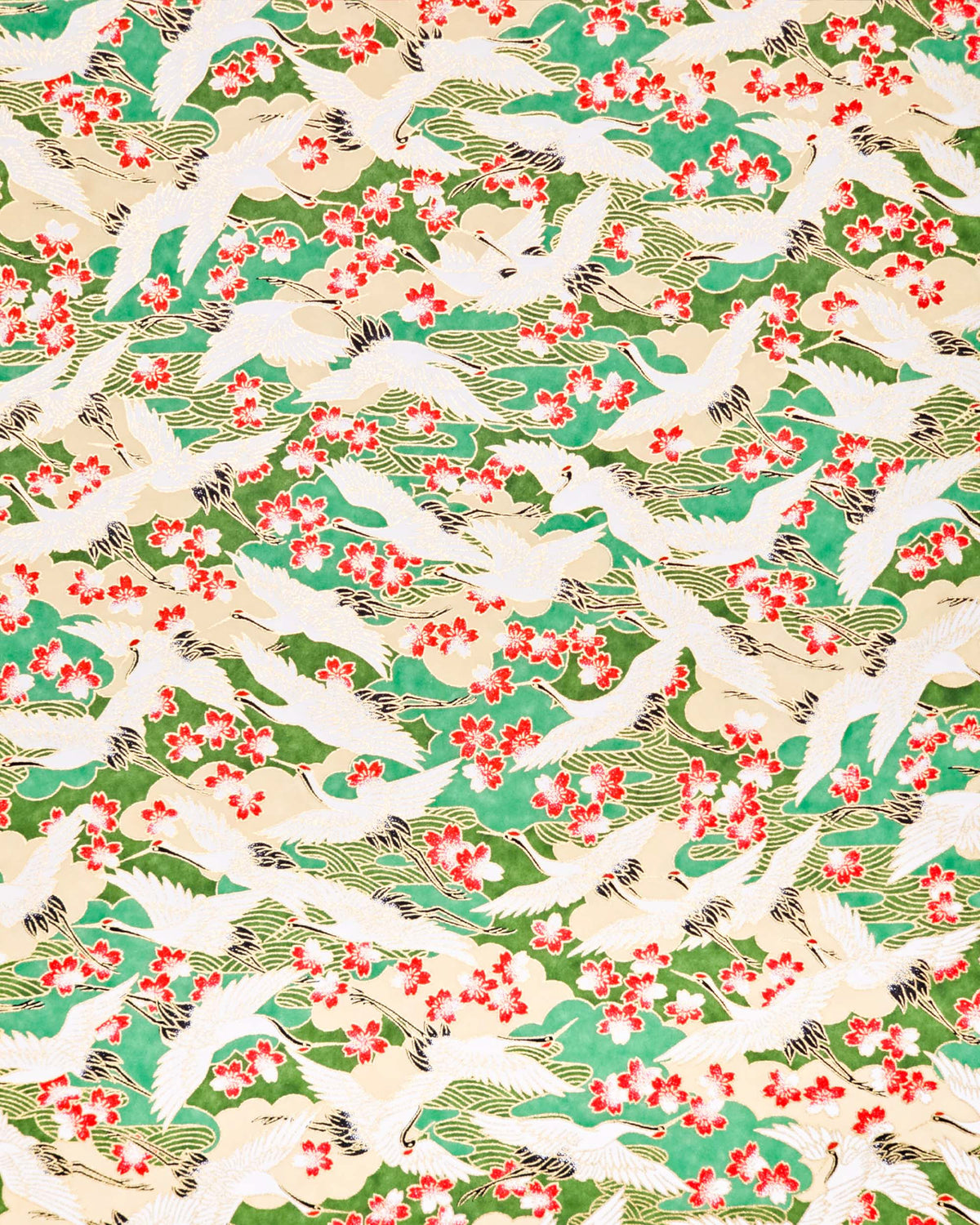 Japanese chiyogami paper featuring white flying cranes and red and white cherry blossoms among beige and green clouds and green waves with metallic gold details.