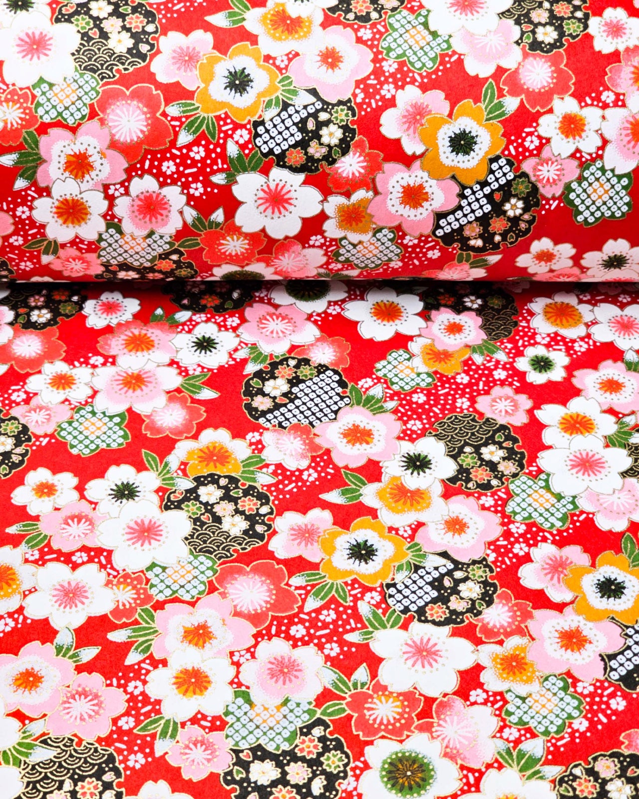 Japanese chiyogami paper featuring cranes and red cherry blossoms on a green and beige background with metallic gold accents.