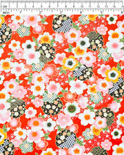 Japanese chiyogami paper featuring cranes and red cherry blossoms on a green and beige background with metallic gold accents.