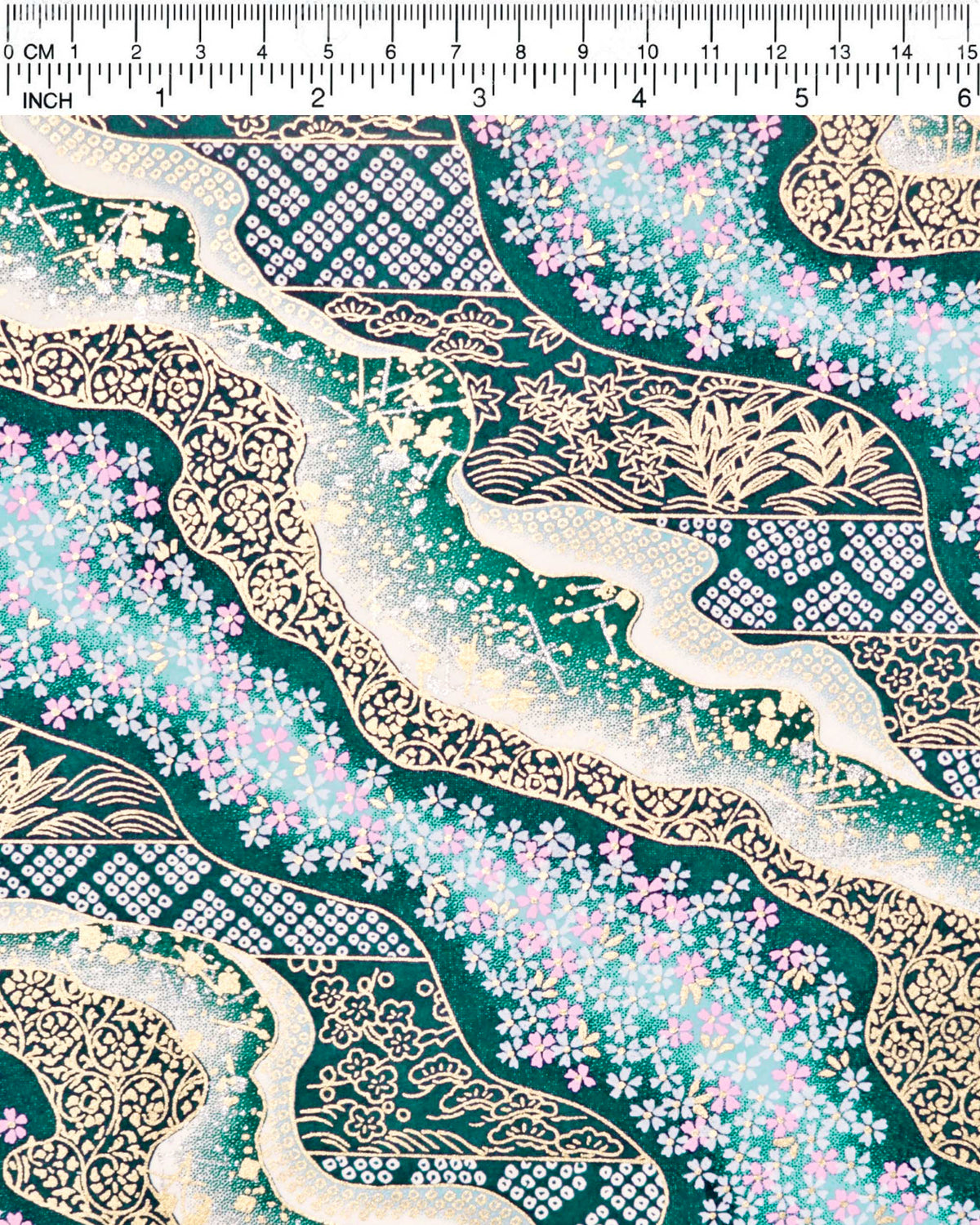Japanese chiyogami paper featuring pink and white cherry blossoms with assorted traditional Japanese floral and geometric patterns on teal blue background with metallic gold and silver details, shown next to a ruler for size reference.