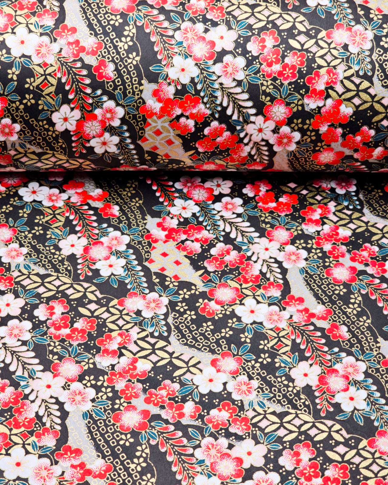 Japanese chiyogami paper featuring red and white plum blossoms with red, white, and green wisteria on a black back ground with metallic gold accents.