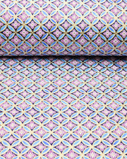Japanese chiyogami paper featuring a blue and metallic gold shippo pattern with purple and white hanabishi (flower diamond) pattern in the center on a black background, shown rolled to highlight the design.