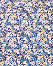 Japanese chiyogami paper featuring pink and yellow plum blossoms and blue, pink, and yellow wisteria on a dark blue background with metallic gold details.