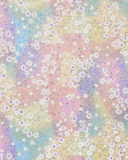Japanese chiyogami paper featuring small white and pastel rainbow-colored flowers with metallic gold details.