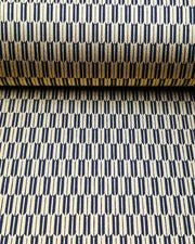 Japanese chiyogami paper featuring a traditional black and metallic gold yagasuri (arrow feather) pattern, shown rolled to highlight the design.
