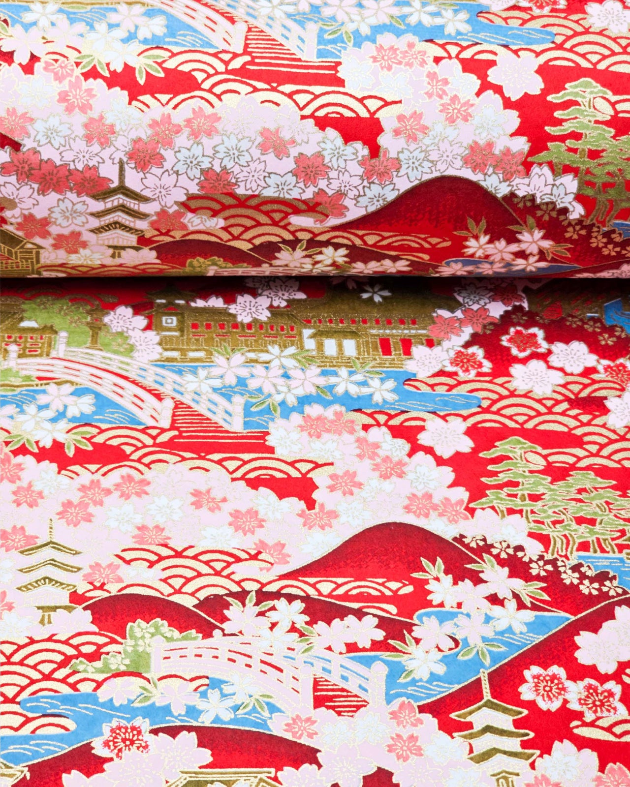 Japanese chiyogami paper featuring a red and pink cherry blossom-filled Japanese village with metallic gold accents.