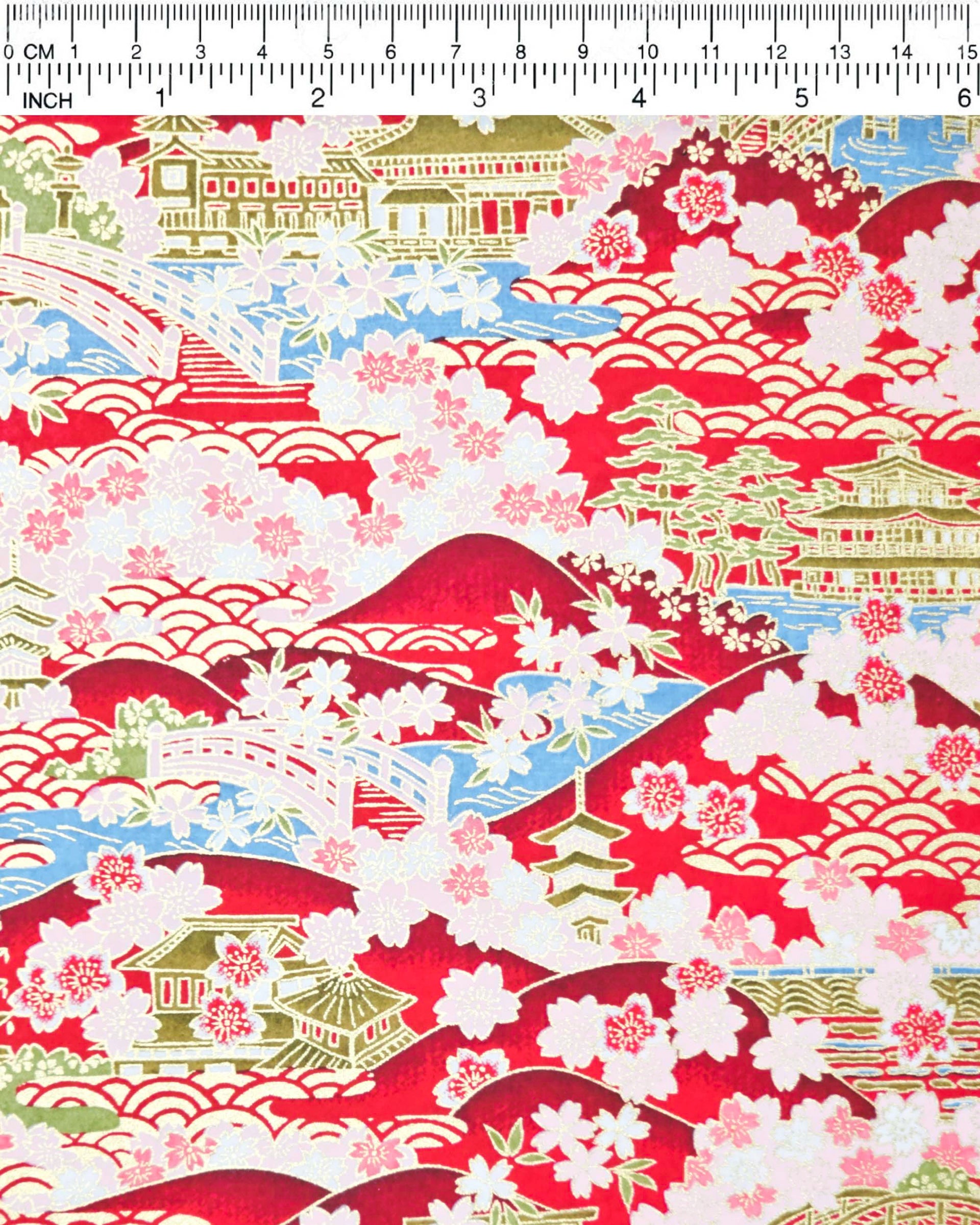 Japanese chiyogami paper featuring a red and pink cherry blossom-filled Japanese village with metallic gold accents.