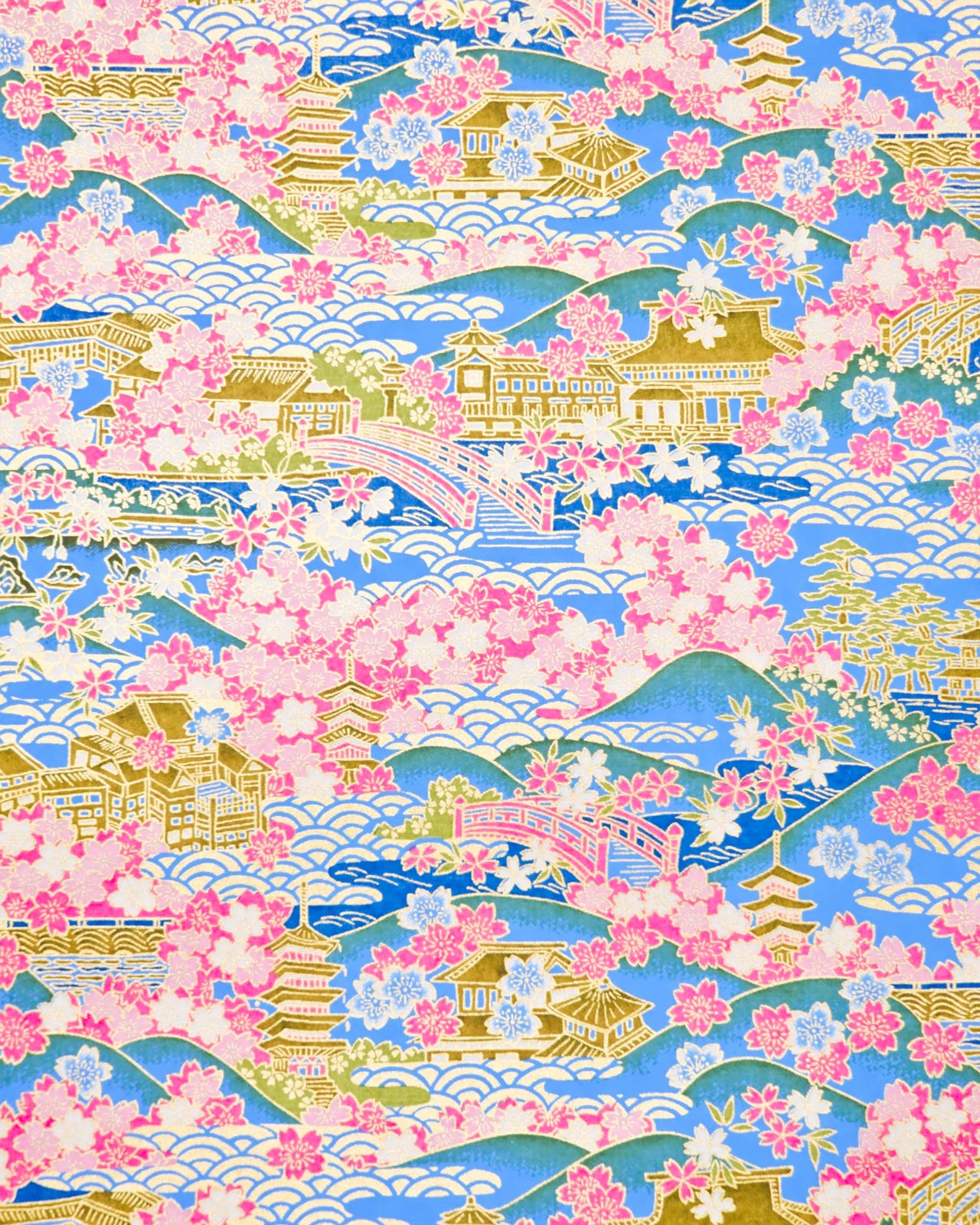 Japanese chiyogami paper featuring a blue and pink cherry blossom-filled Japanese village with metallic gold accents.