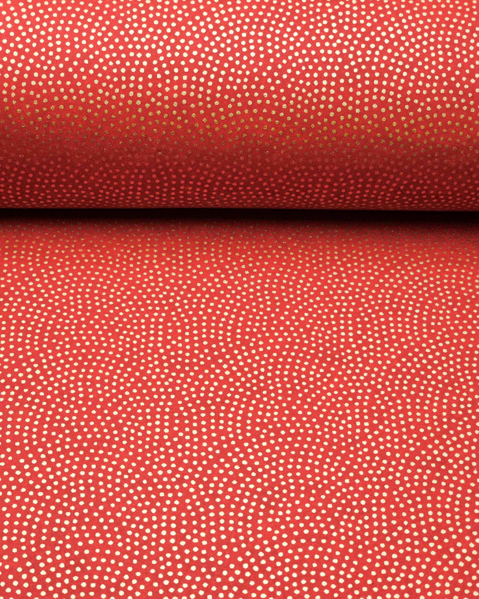 Japanese chiyogami paper featuring a metallic gold "same komon" (sharkskin) design on a maroon red background.