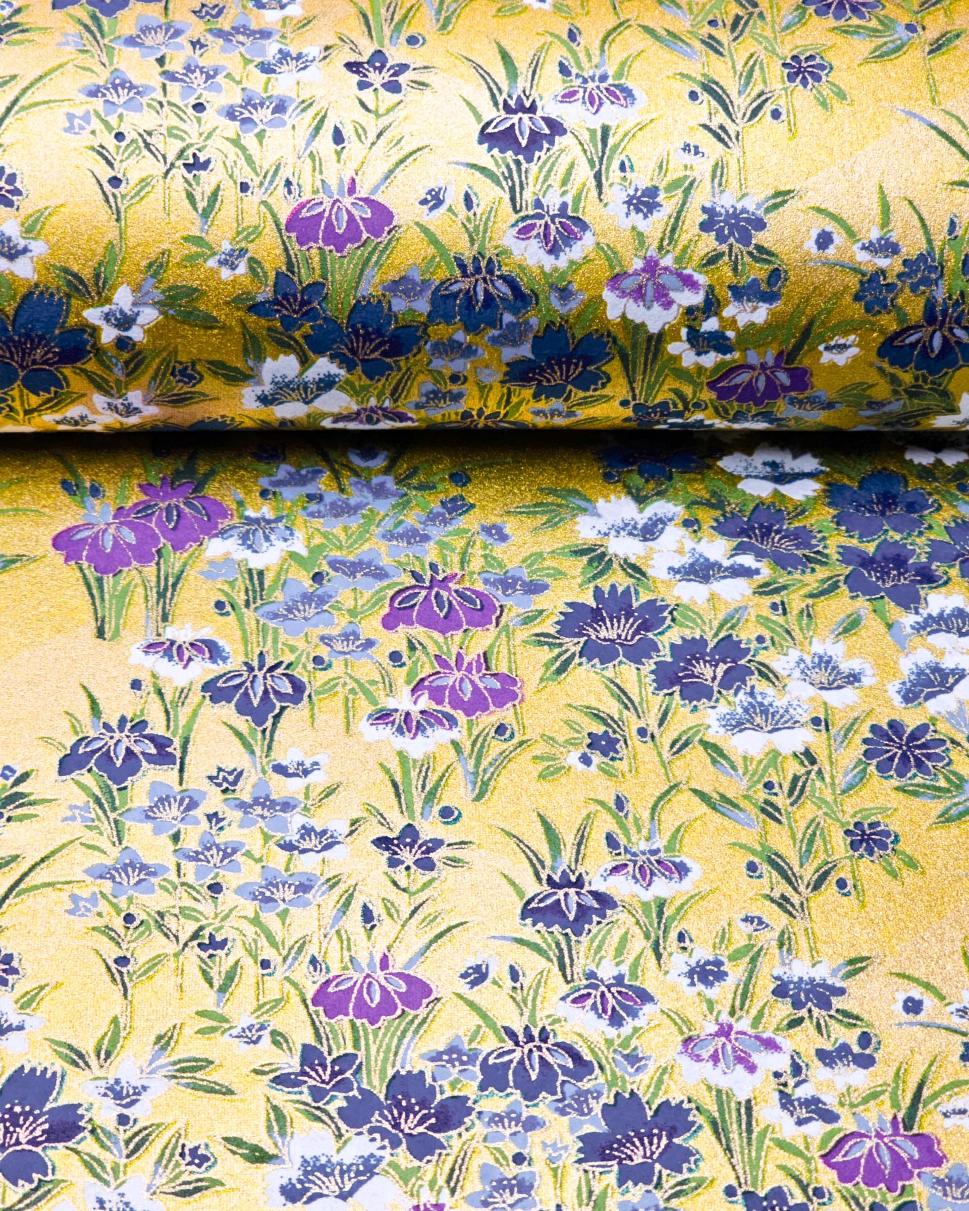 Japanese chiyogami paper featuring blue, purple, and white irises on a gold background with metallic gold accents.