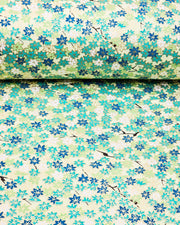 Japanese chiyogami paper featuring small green and white momiji (maple leaves) on a light green background with metallic gold details.