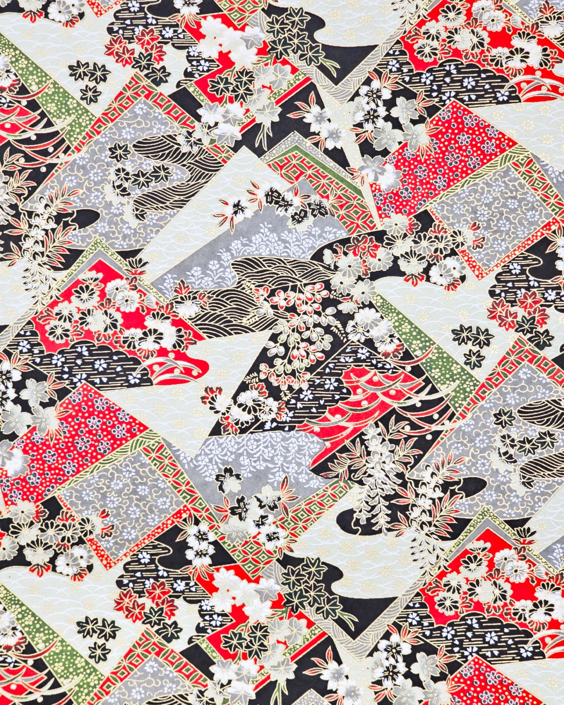 Japanese chiyogami paper featuring red, gray, black, off white, and green patches adorned with an assortment of various floral and geometric patterns with metallic gold details.