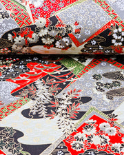 Japanese chiyogami paper featuring red, gray, black, off white, and green patches adorned with an assortment of various floral and geometric patterns with metallic gold details.