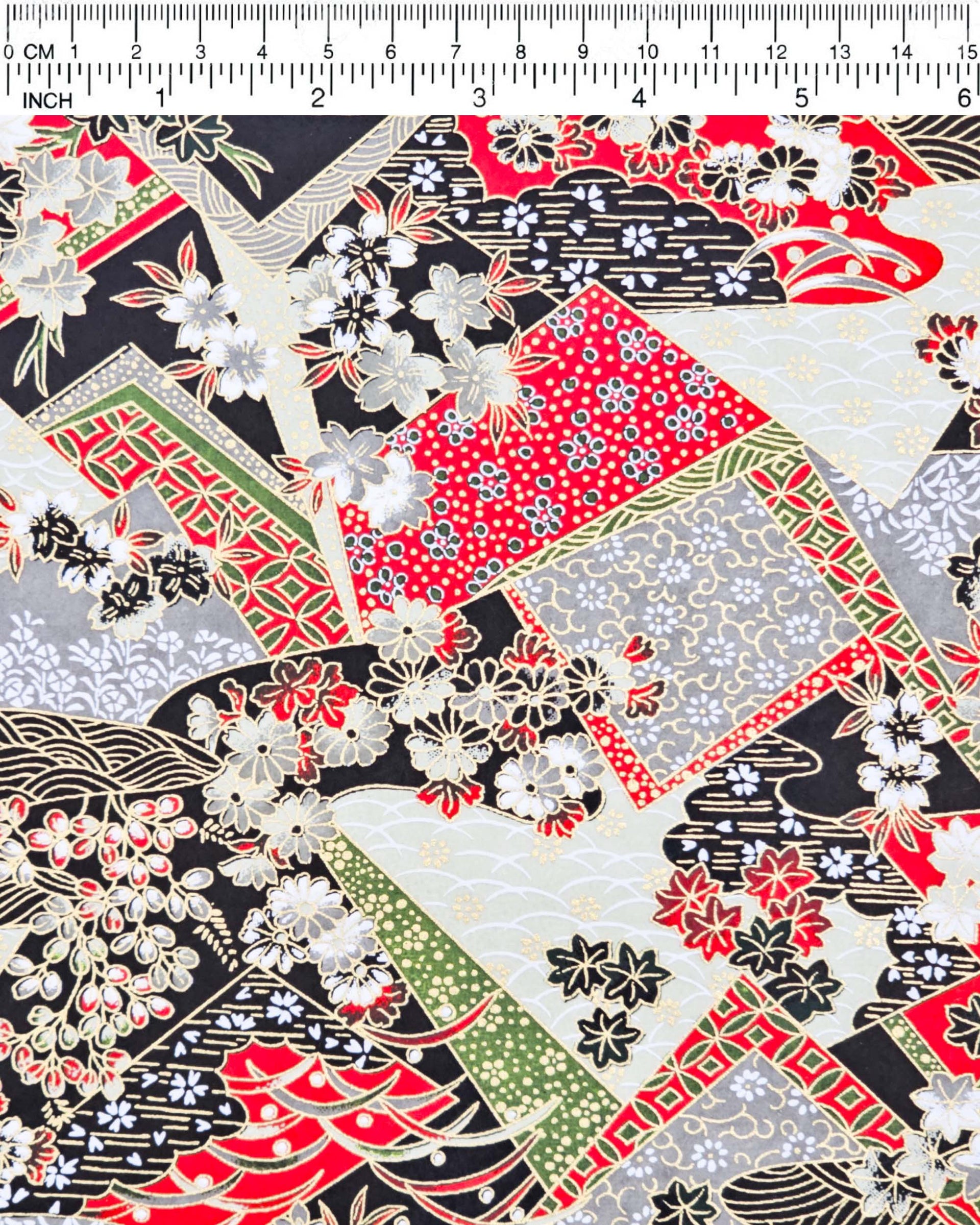 Japanese chiyogami paper featuring red, gray, black, off white, and green patches adorned with an assortment of various floral and geometric patterns with metallic gold details.