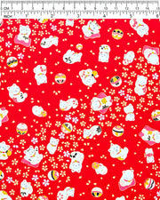 Japanese chiyogami paper featuring assorted white and red Maneki Neko (lucky cats) with small white and gold cherry blossoms and temari balls on a bright red background with metallic gold details.