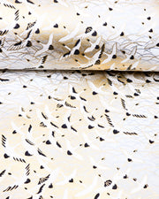 Japanese chiyogami paper featuring pearlescent white flying cranes in a zigzag formation on a white background with metallic gold and silver details.