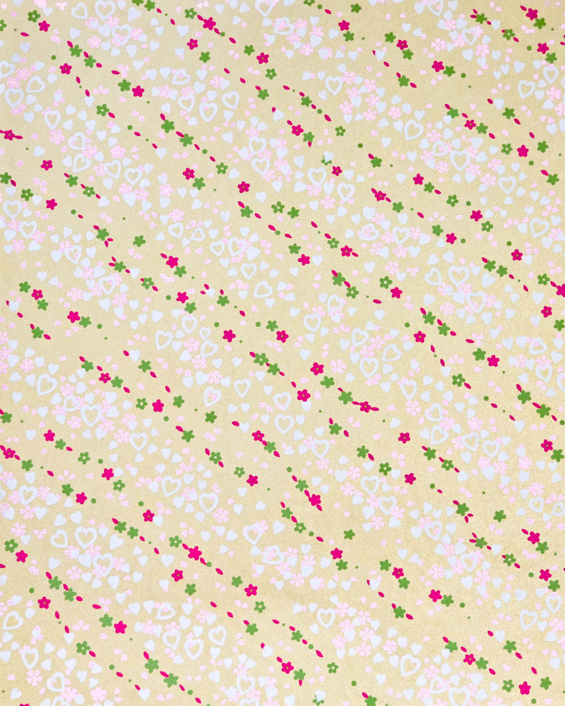 Japanese chiyogami paper featuring white hearts, small red and green flowers, and pink cherry blossoms on a metallic gold background.