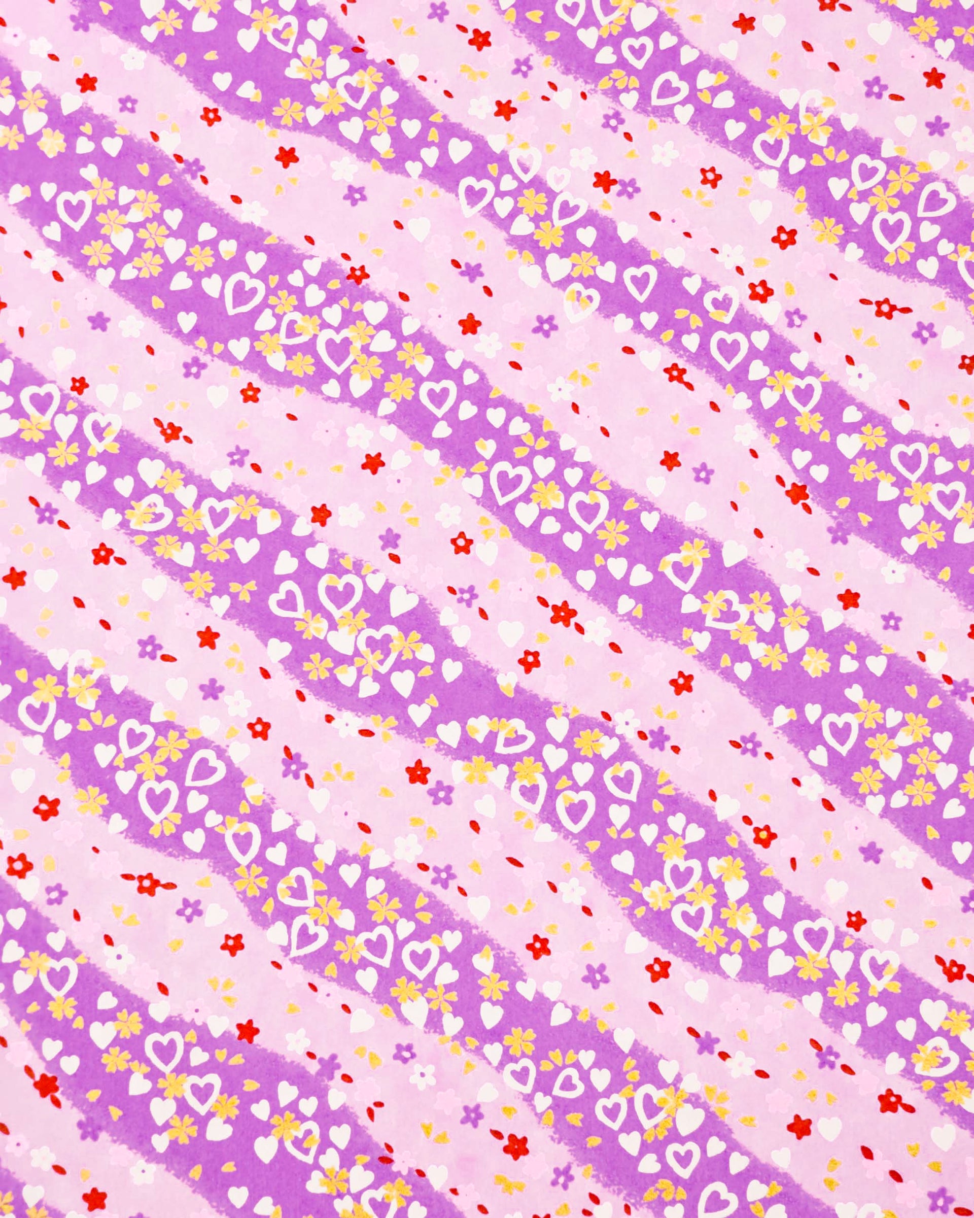 Japanese chiyogami paper featuring white hearts, small pink, red, and purple flowers, and metallic gold blossoms on a purple gradient background.