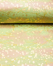 Japanese chiyogami paper featuring scattered metallic gold geometric shapes and fine gold lines on a green background.