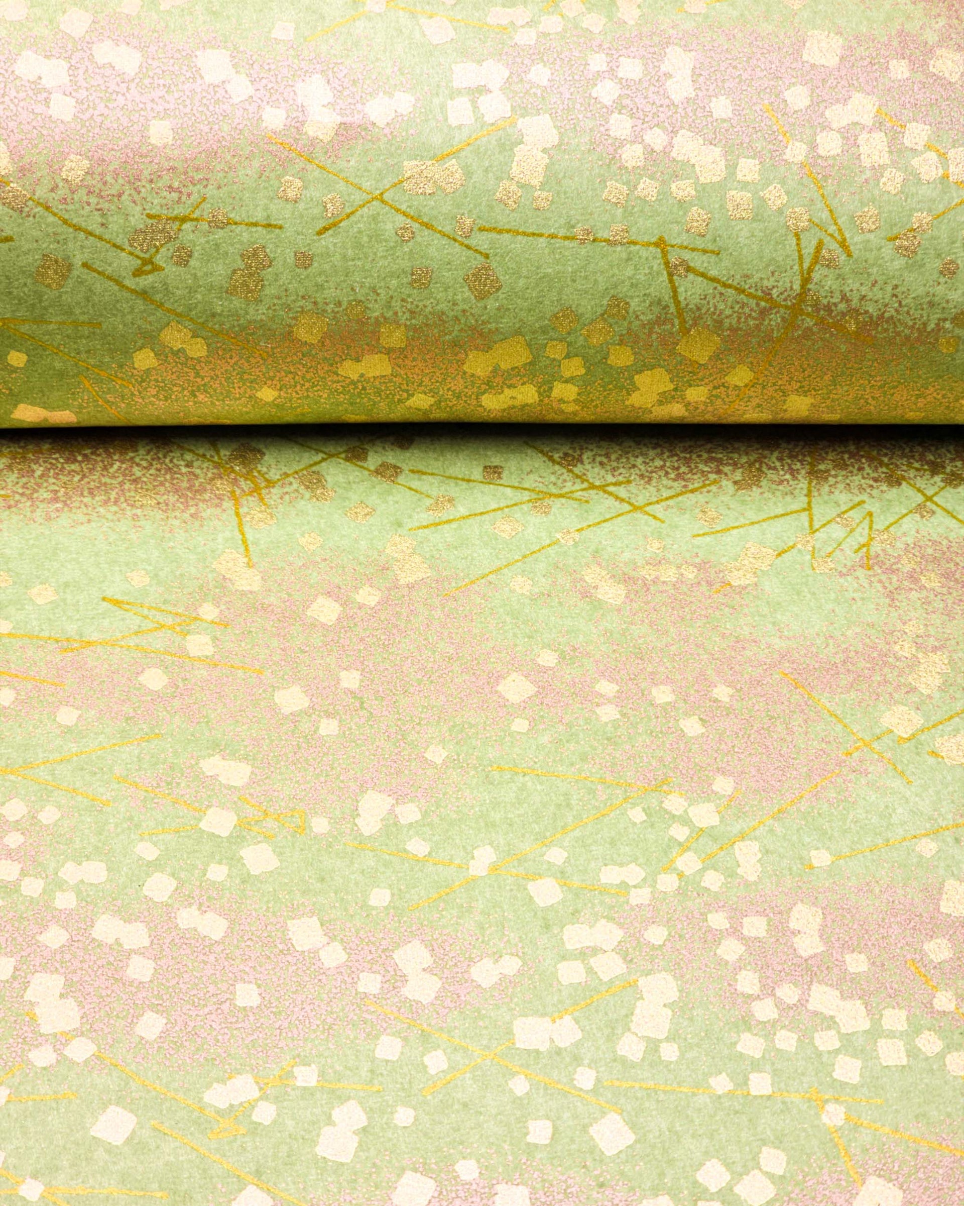 Japanese chiyogami paper featuring scattered metallic gold geometric shapes and fine gold lines on a green background.