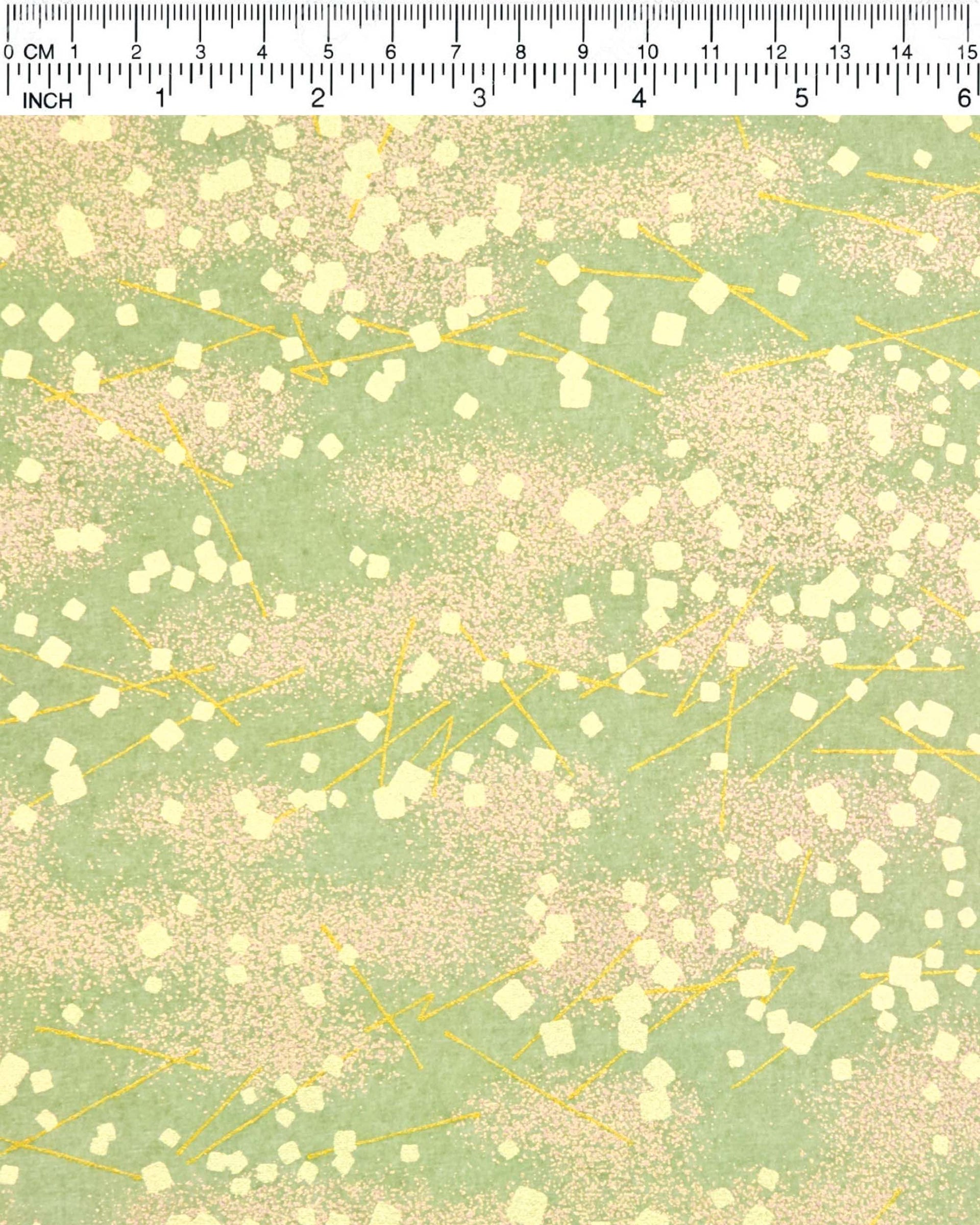 Japanese chiyogami paper featuring scattered metallic gold geometric shapes and fine gold lines on a green background.